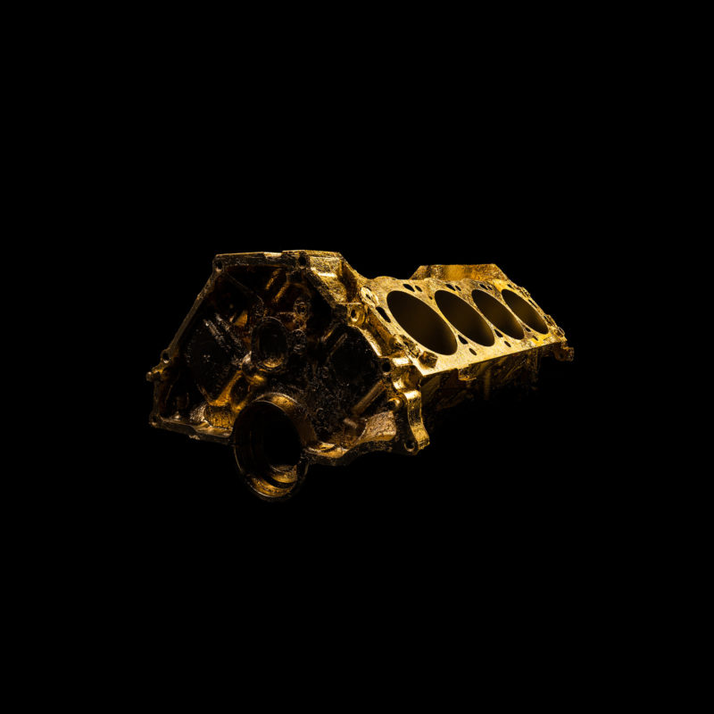 A photograph of a gold engine block.