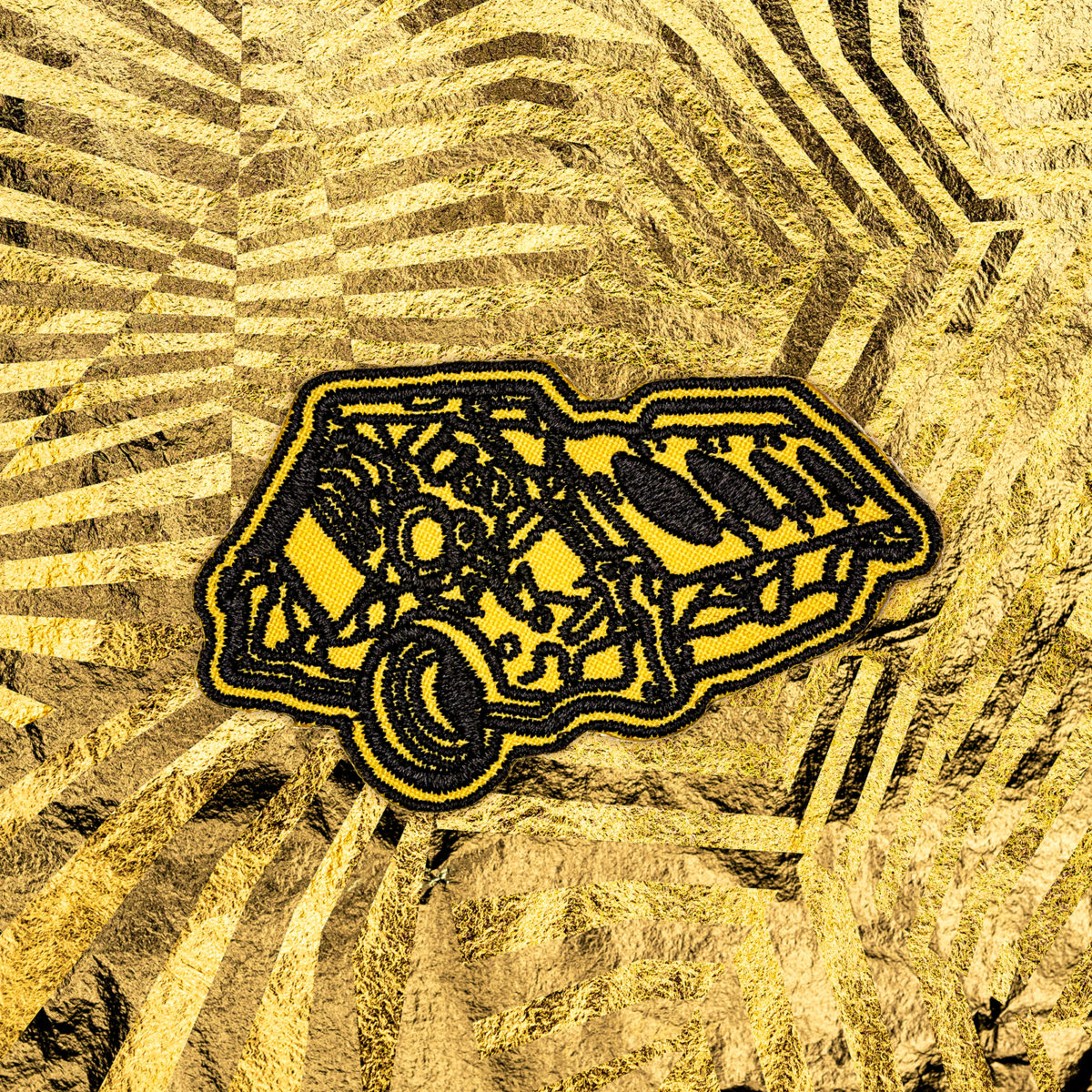 A picture of a fabric patch of a gold engine block.