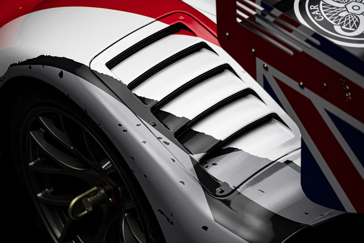A closeup photo of a Radical RXC racecar rear fender