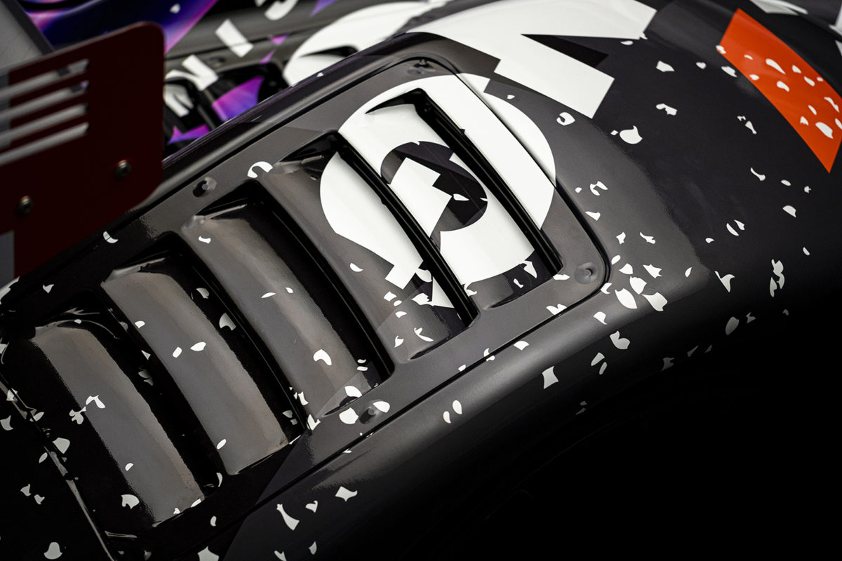 A closeup photo of a Radical RXC racecar fear fender